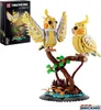 A LEGO-style building block model of two cockatiels perched on a tree branch, with a box of the product in the background. Náhľad obrázku produktu
