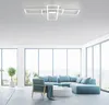 A modern living room with a sectional sofa, armchair, and coffee table, illuminated by a contemporary ceiling light fixture. Large windows offer a view of a scenic landscape. Produktbild-Vorschau