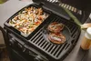 A grill with food being cooked on it. Produktbild-Vorschau