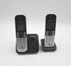 Two Panasonic cordless phones are shown on their charging bases against a white background. Voir les images du produit
