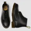 A pair of black Dr. Martens boots shown from a top-down and side view on a white background. Voir les images du produit