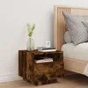 A bedside table with books and a vase of plants next to a bed. Produktbild-Vorschau