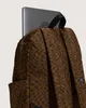 A close-up view of the back of a backpack with a laptop partially inserted. Podgląd zdjęcia produktu