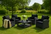 A set of outdoor furniture including four chairs and a coffee table, arranged on a grassy lawn with trees in the background. Voir les images du produit