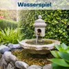 A stone water fountain in a garden setting with lush green foliage. Produktbild-Vorschau