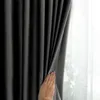 A hand is shown pulling back a dark gray curtain to reveal a sheer white curtain behind it. Produktbild-Vorschau