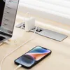 A desk setup with a laptop and smartphone charging via a built-in power strip. Produktbild-Vorschau