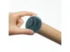 A hand holding a gray circular attachment on a wooden rolling pin. Produktbild-Vorschau