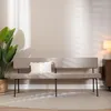 A bench in a room with a plant and a lamp. Produktbild-Vorschau