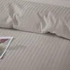 A close-up of a striped taupe duvet cover and pillowcase. Podgląd zdjęcia produktu