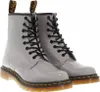 A pair of gray patent leather Dr. Martens boots.