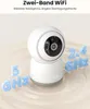A white security camera is shown with text overlays indicating its dual-band WiFi capabilities. Produktbild-Vorschau