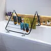 A drying rack with socks and a towel placed over a bathtub. Produktbild-Vorschau