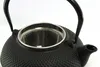 Close-up of a black cast iron teapot with a metal tea strainer. Podgląd zdjęcia produktu