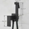 A black bidet sprayer and holder mounted on a tiled wall, with dimensions indicated by measurement lines and text. Náhľad obrázku produktu