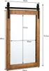 A mirror with a wooden frame and a black metal sliding door hardware is shown with dimensions indicated by lines and text. Náhled obrázku produktu