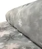 A roll of grey fleece fabric with a snowflake pattern. Produktbild-Vorschau