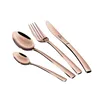 A set of rose gold cutlery, including a knife, fork, and two spoons, arranged diagonally on a white background. Podgląd zdjęcia produktu