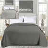 A bedroom setting with a bed and bedding. Náhled obrázku produktu