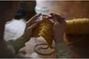 A person is crocheting with yellow yarn and a purple crochet hook. Podgląd zdjęcia produktu