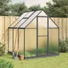 A greenhouse with gardening tools in a backyard setting. Voir les images du produit