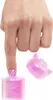 A finger with a nail polish application is shown over a pink glitter container, with a pink cap nearby. Podgląd zdjęcia produktu