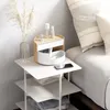 A white bedside table with a makeup organizer and a vase of dried flowers. Náhled obrázku produktu