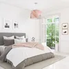 A bedroom scene with a bed, bedside tables, and a window overlooking a balcony with greenery. Produktbild-Vorschau