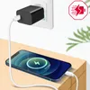 A black fast charger is plugged into a white wall socket, with a white charging cable connected to a blue smartphone that is charging on a wooden surface. Produktbild-Vorschau