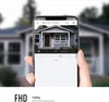 A hand holding a smartphone displaying a security camera feed of a house. Produktbild-Vorschau