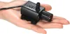 A small black water pump is held in a person's palm. Podgląd zdjęcia produktu