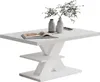 A white rectangular coffee table with a modern, geometric base, decorated with two vases and an open book. Produktbild-Vorschau