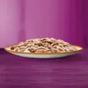A close-up, side view of a white plate filled with cat food, set against a blurred purple background. Produktbild-Vorschau