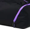 A close-up view of a black duffel bag with a purple zipper. Produktbild-Vorschau