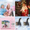 Collage of images showcasing the features of a pink digital camera, including children using it, a family celebrating, and a cat in motion. Produktbild-Vorschau