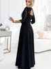 A woman wearing a black dress stands in a well-lit room with modern furniture. Anteprima dell’immagine prodotto