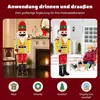 A collage showing a large illuminated nutcracker figure used as Christmas decoration indoors and outdoors, with children playing in the snow in one scene. Icons at the bottom suggest different placement locations. Produktbild-Vorschau