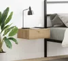 A modern bedroom scene with a floating nightstand next to a bed. Náhled obrázku produktu