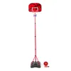 A red adjustable basketball hoop with a basketball and pump on a white background. Podgląd zdjęcia produktu