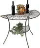 A metal half-round table with two bottles of wine and a floral arrangement on top, and a potted plant on the lower shelf. Produktbild-Vorschau