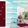 A woman is meditating on a yoga mat outdoors, with instructional text and graphics overlaid on the image. Produktbild-Vorschau
