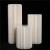 Three white pleated cylindrical stands of varying heights against a black background. Podgląd zdjęcia produktu