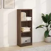 A tall, narrow bookshelf with three shelves, filled with books and a box, placed against a white wall. Podgląd zdjęcia produktu
