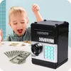A young child is excitedly looking at a toy safe and money. Náhled obrázku produktu