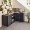 An outdoor kitchen setup with a sink, cabinets, shelves, and a backsplash, decorated with hanging plants. Anteprima dell’immagine prodotto