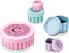Several small, round gift boxes with striped patterns and branded lids are arranged on a white background. Produktbild-Vorschau