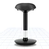 A black wobble stool on a grid pattern floor. Náhled obrázku produktu