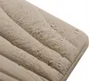 Close-up of a beige, quilted fabric with water droplets on it. Produktbild-Vorschau