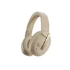 A pair of beige over-ear headphones with a gold accent. Podgląd zdjęcia produktu