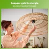 A woman is changing a light bulb in a rattan lampshade. Produktbild-Vorschau